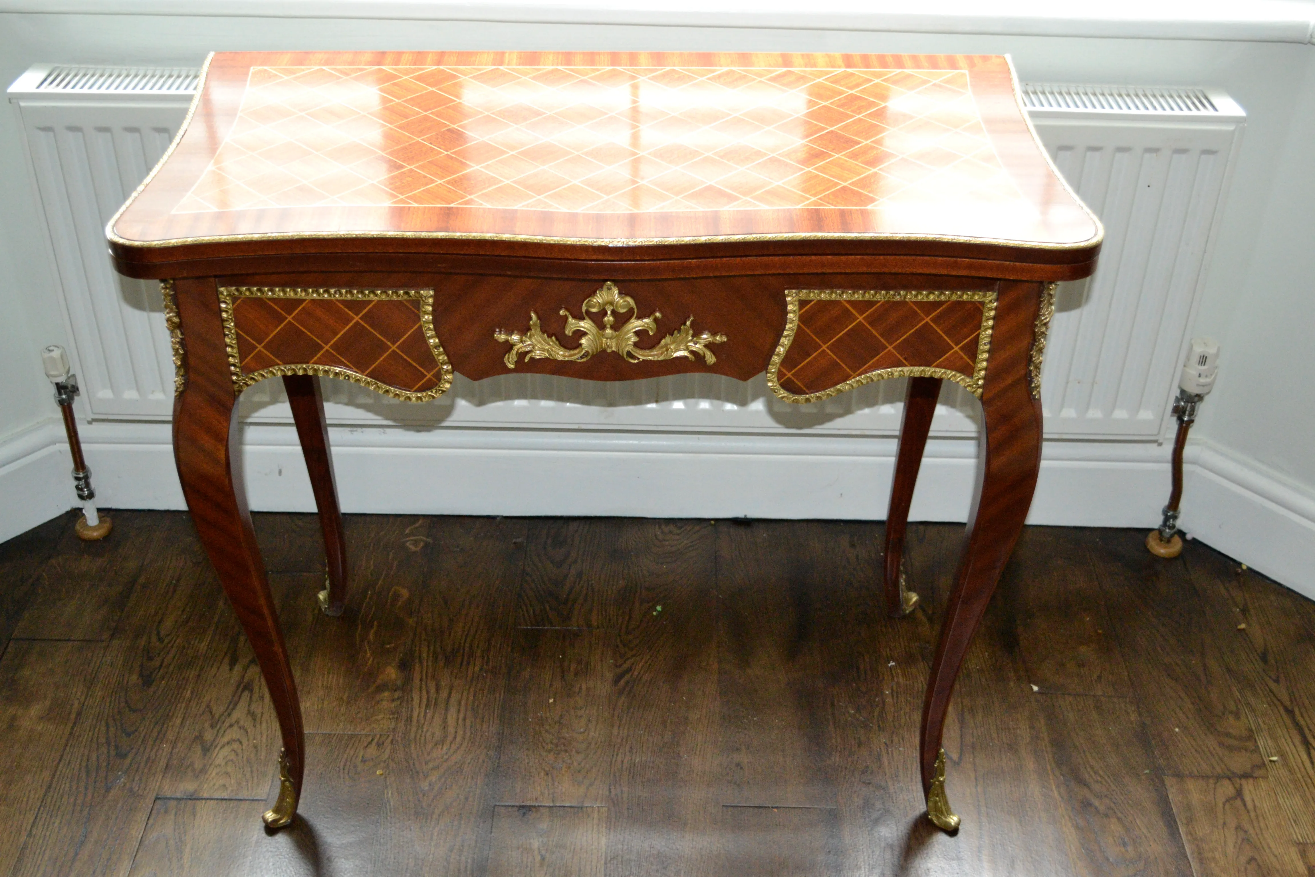 A restored marquetry side table with gilt mounts