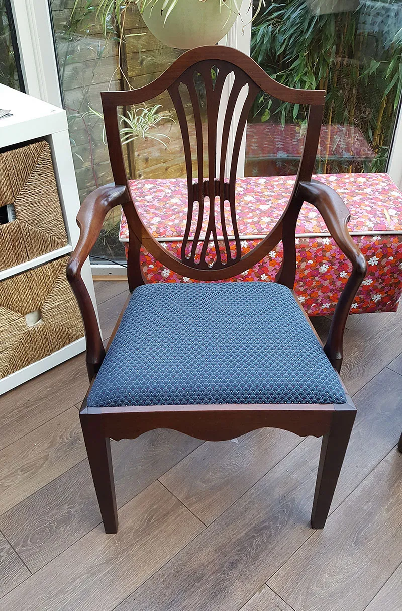 The same shield-back chair restored, with a new blue seat