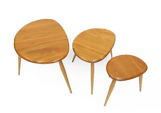 A nest of three pebble-shaped tables in a pale wood